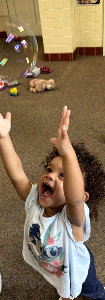 A young child playing with bubbles